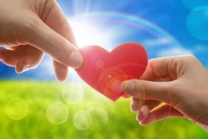 Female and man's hands with red heart